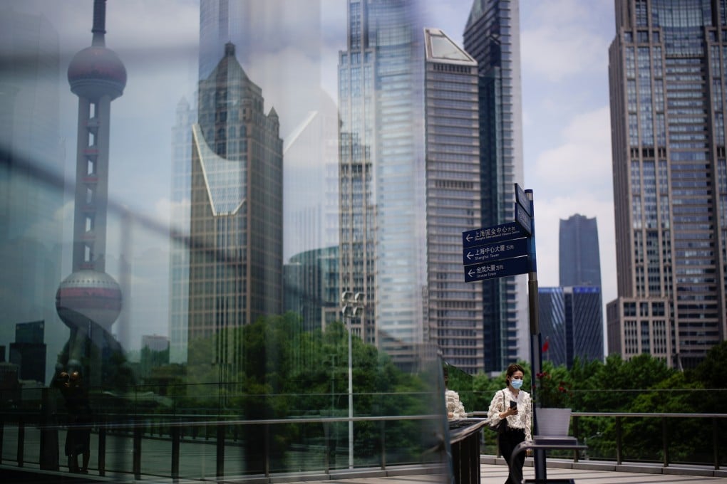 A woman wearing protective face mask at the Lujiazui financial district in Pudong, Shanghai, on May 22, 2020. Photo: Reuters