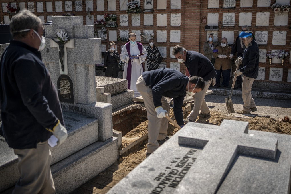 A coronavirus victim is buried at the Almudena cemetery in Madrid, Spain. Photo: AP