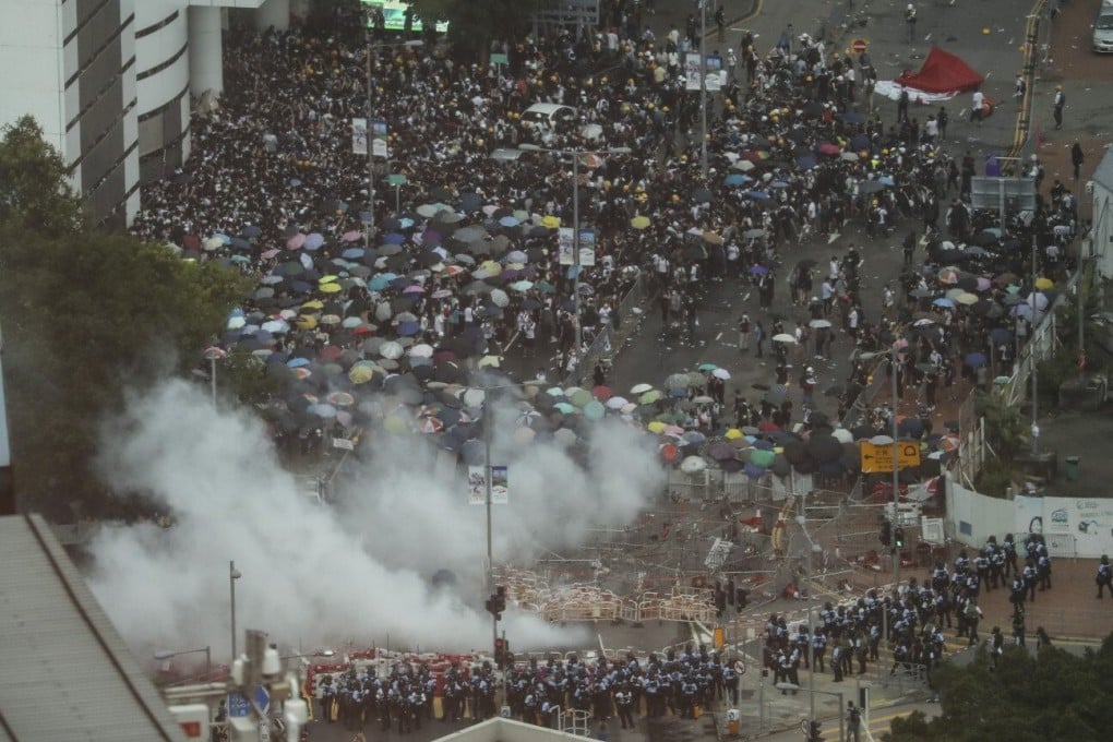 Protesters rush into Citic Tower as police fire tear gas on June 12, 2019. Photo: Handout