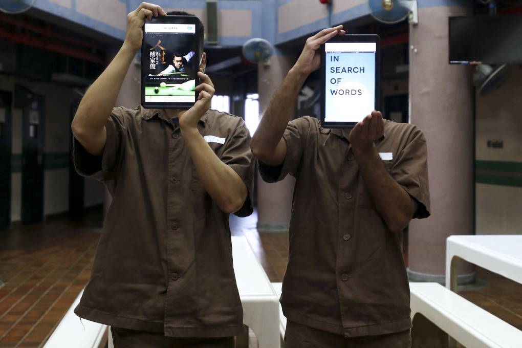 (Left to right) Stanley Prison inmates Sam and Tony show their favourite tablet contents. Photo: Xiaomei Chen