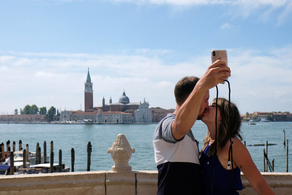 Tourists take a selfie in Venice on Sunday, a day before Italy and neighbouring EU countries open up borders for the first time since the coronavirus lockdown began. Photo: Reuters