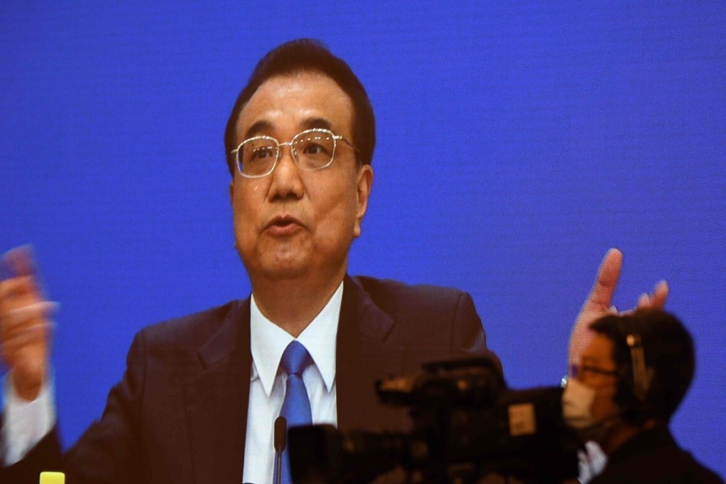 Chinese Premier Li Keqiang is seen on a screen during a press conference held via online video link following the National People's Congress at the Great Hall of the People in Beijing on May 28, 2020. - China's rubber-stamp parliament endorsed plans May 28 to impose a national security law on Hong Kong that critics say will destroy the city's autonomy. (Photo by Noel Celis / AFP)