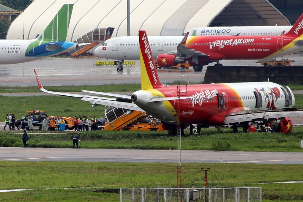 A VietJet Air Airbus A321neo passenger plane is seen on a grass field after skidding off the runway while landing in heavy rain at Tan Son Nhat International Airport in Ho Chi Minh City. Photo: EPA-EFE