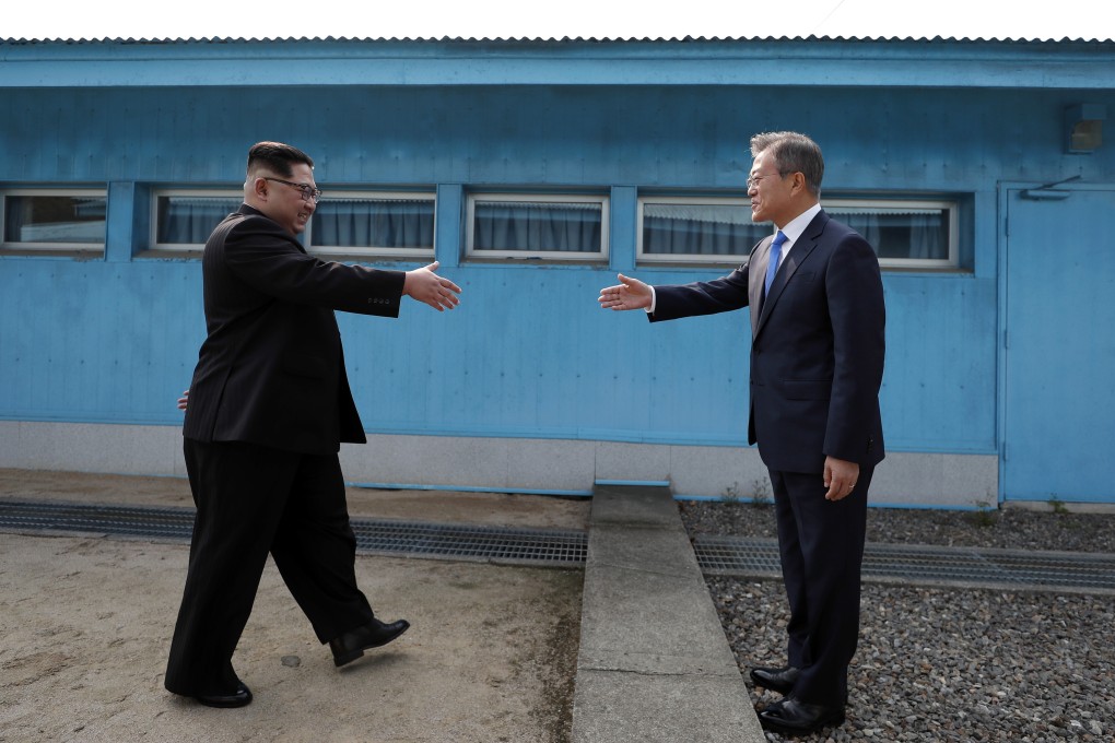 North Korean leader Kim Jong-un (left) shakes hands with South Korean President Moon Jae-in at the Joint Security Area in the demilitarised zone during their 2018 summit. Photo: EPA
