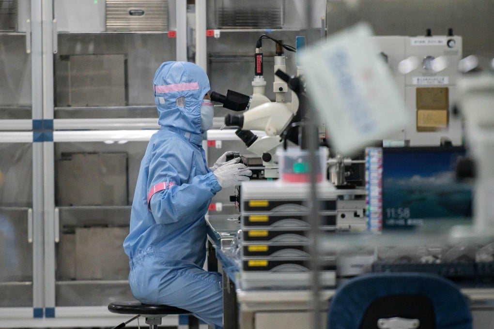 A worker is seen inside the production line at Japanese chip company Renesas Electronics in Beijing on May 14. Asia’s electronics sector has continued to grow, despite the disruptions caused by the coronavirus pandemic. Photo: Agence France-Presse