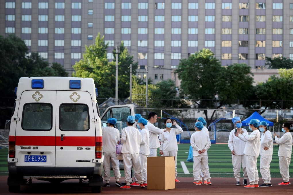 On Sunday, medical personnel wearing protective suits gather before swab testing people who have recently visited Xinfadi Market in Beijing or live near the market. Photo: AFP