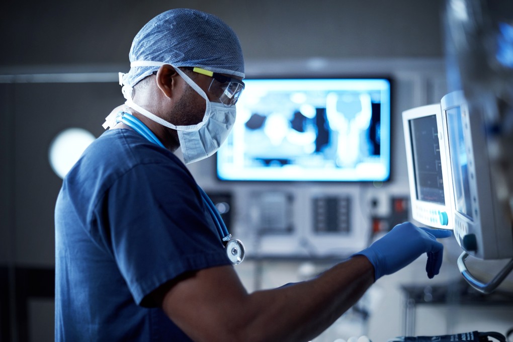 A surgeon looking at a monitor in an operating room. Hygeia joins a host of medical services providers making a beeline to list in Hong Kong. Photo: Shutterstock