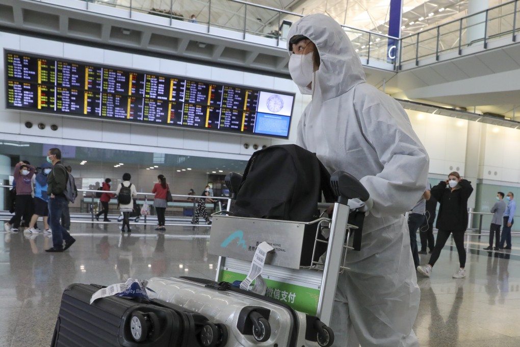 University student Amy Chan walks through Hong Kong International Airport on March 16 after returning from her studies in the United Kingdom amid the Covid-19 pandemic. Photo: K.Y. Cheng