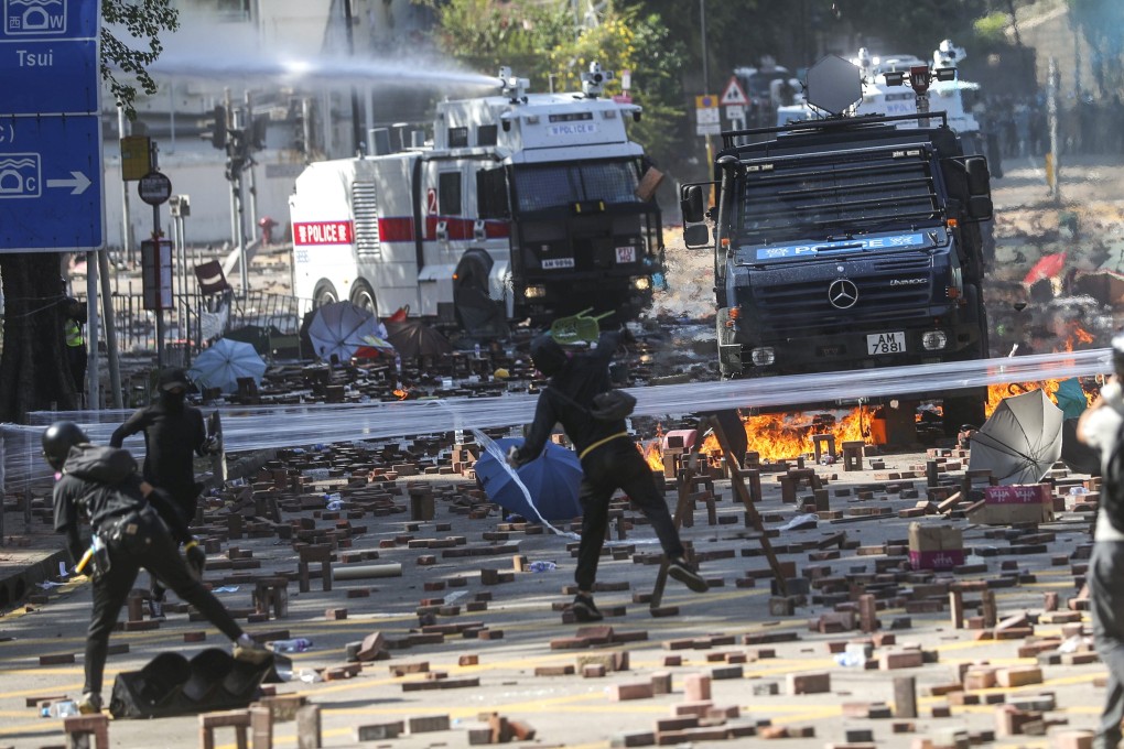 Two water cannon and an armoured vehicle arrive as clashes break out between riot police and students outside Polytechnic University. Photo: Sam Tsang