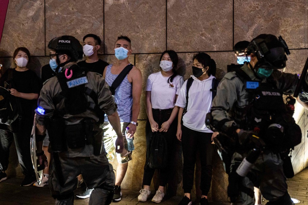 Protesters stand against a wall after being detained by police in Mong Kok, Hong Kong, on June 12. Photo: AFP