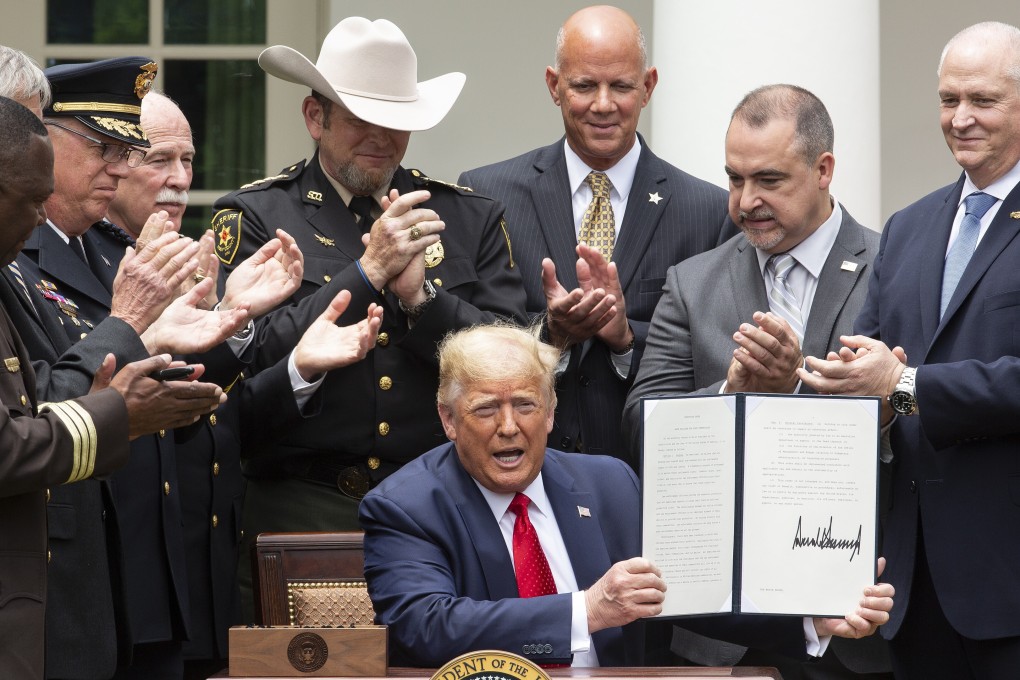 US President Donald Trump holds an executive order on Safe Policing for Safe Communities after being signing it in the Rose Garden of the White House on Tuesday. Photo: Bloomberg