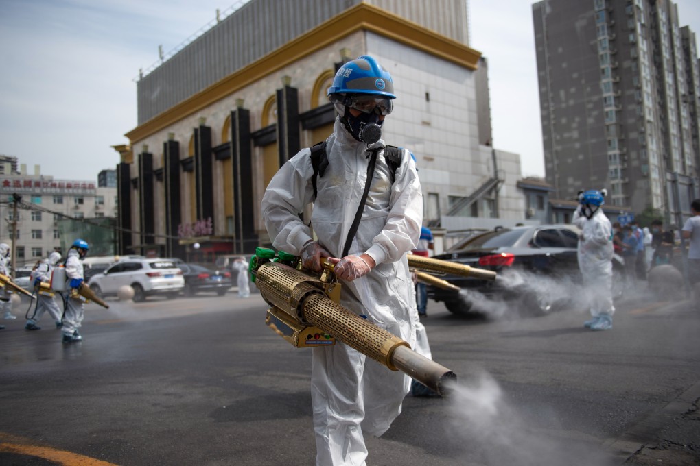 Workers disinfect the Yuegezhuang wholesale market in Beijing on Tuesday amid a fresh outbreak of coronavirus cases. Photo: Xinhua