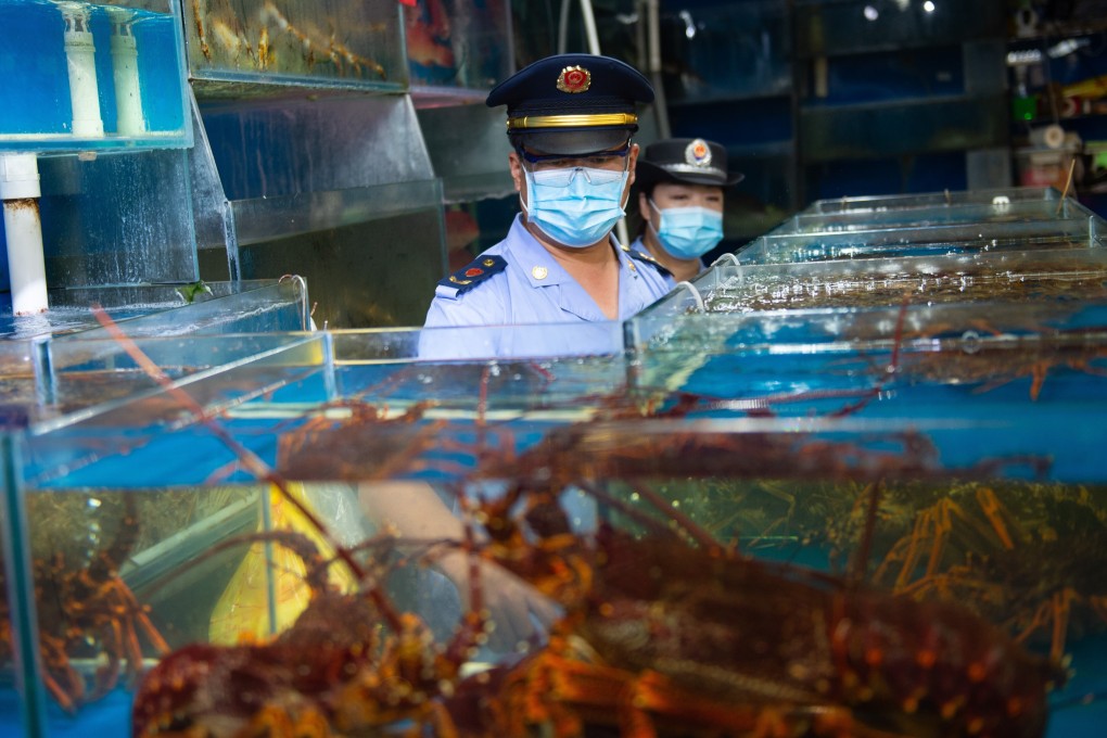 A seafood stall is inspected at a Beijing wholesale food market. Photo: Xinhua