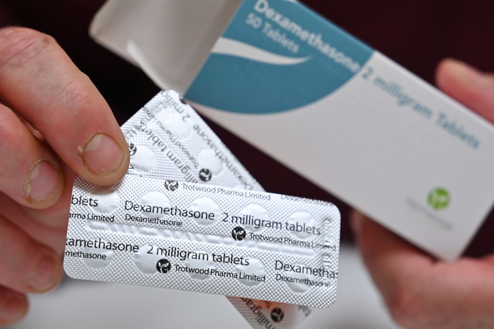 A pharmacist holds a box of dexamethasone tablets in London on Tuesday. Photo: AFP