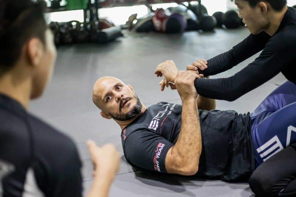 Head coach Siyar Bahadurzada teaches his students how to defend in bottom guard position. Photo: Evolve MMA