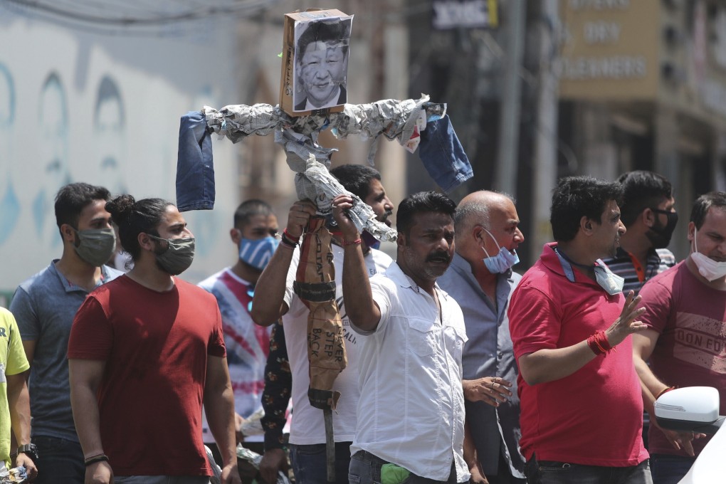 A man holds an effigy of Chinese President Xi Jinping before burning it during a protest against the Chinese government in Jammu, India on Wednesday. The latest clashes between China and India in the Himalayas have escalated a dispute that has been building for months. Photo: AP