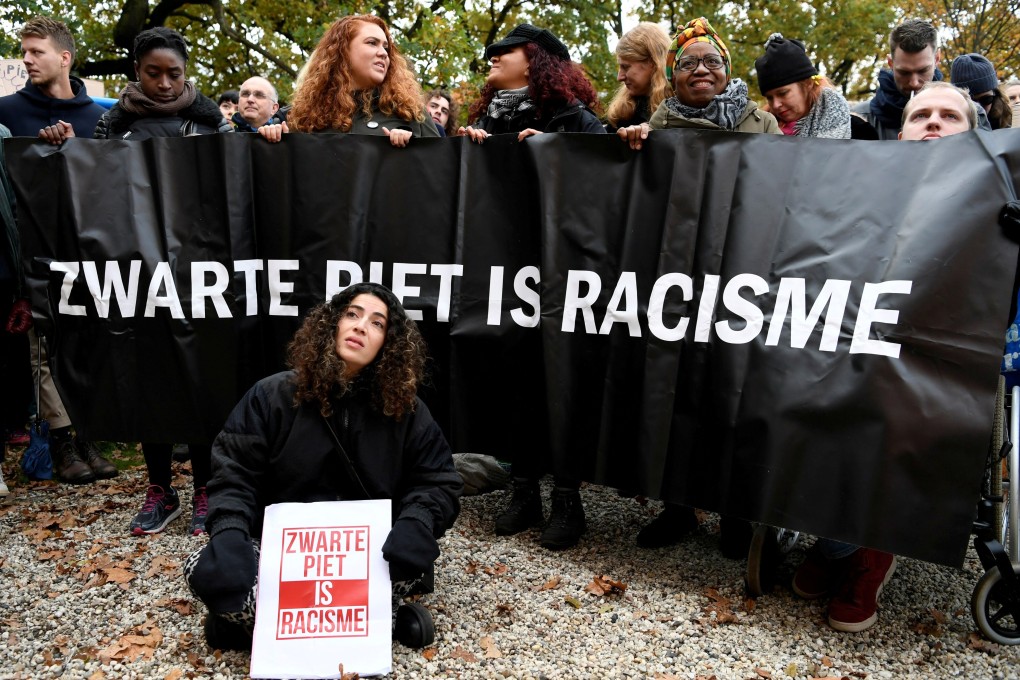 People protest against the arrival of Saint Nicholas and his assistants called “Zwarte Piet” (Black Pete) in The Hague, Netherlands. Photo: Reuters