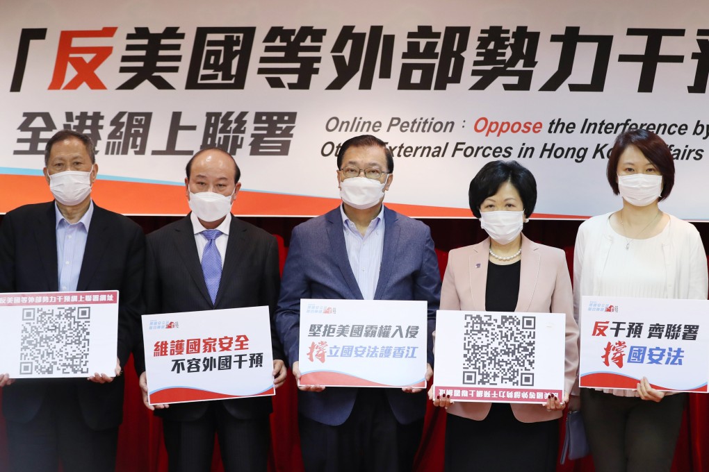 Hong Kong’s pro-establishment lawmakers, who have formed a “united front” to support national security legislation and protest against “foreign interference in Hong Kong affairs”, as stated in their banner, attend a press conference on June 15. Photo: Xinhua