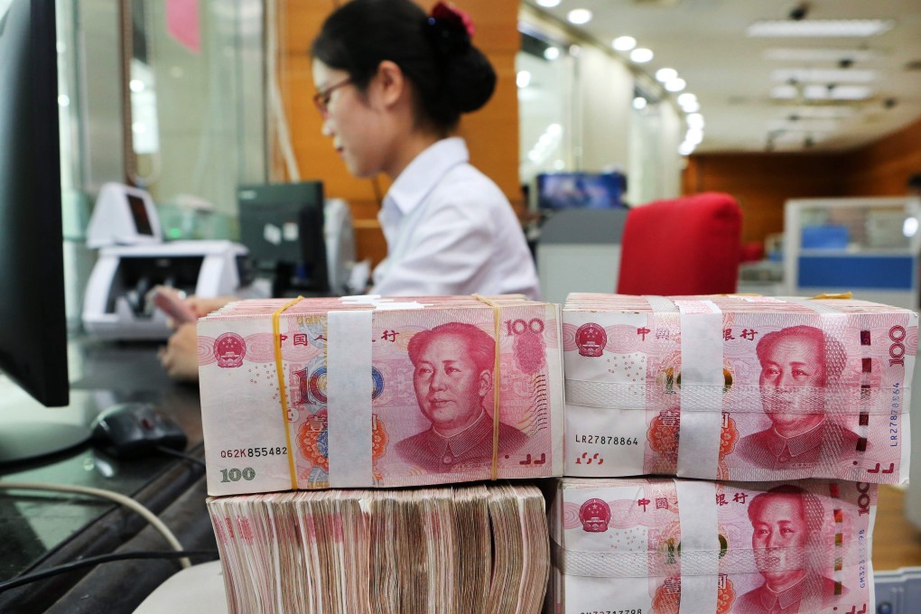 An employee counts 100-yuan notes at a bank in Nantong in China's eastern Jiangsu province on July 23, 2018. China on July 23 rejected accusations by US President Donald Trump that it was manipulating the yuan to give its exporters an edge, saying Washington appeared "bent on provoking a trade war". / AFP PHOTO / - / China OUT