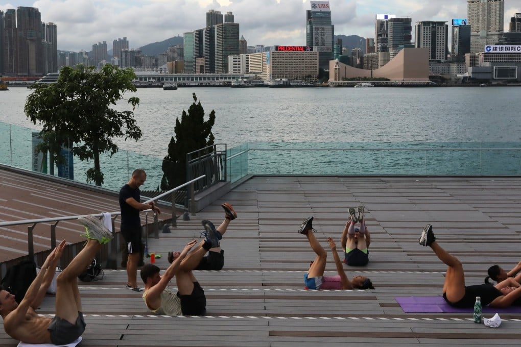 A group of people exercising together at Tamar Park, Admiralty, Hong Kong during the coronavirus pandemic. It has shaken up people’s routines, brought family members closer together, and fostered the practise of mindfulness, experts observe. Photo: K.Y. Cheng