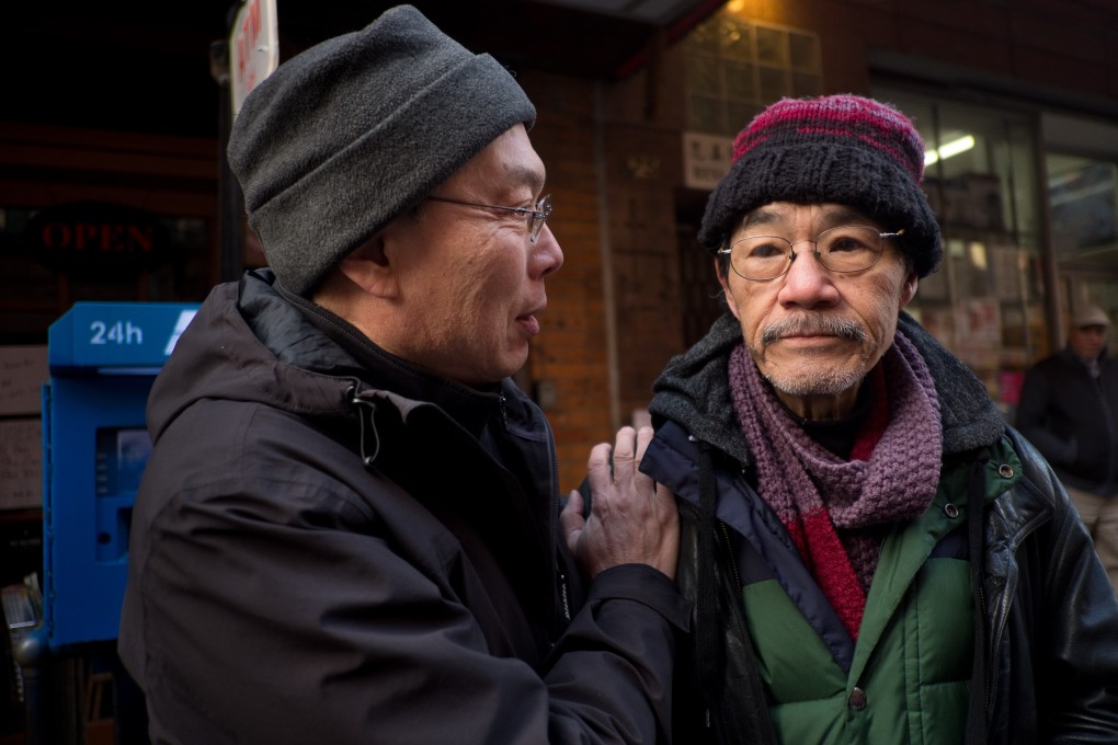 Jack Tchen (left), a co-founder of the Museum of Chinese in America, with one of the building’s former tenants. Photo: Alan Chin