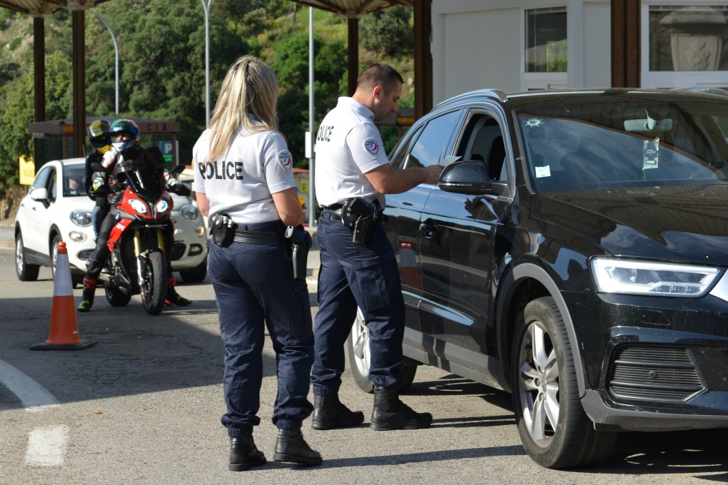 Police officers check cars at La Jonquera border crossing with France after it reopened following the end of the state of alarm in Spain on Sunday. Photo: DPA