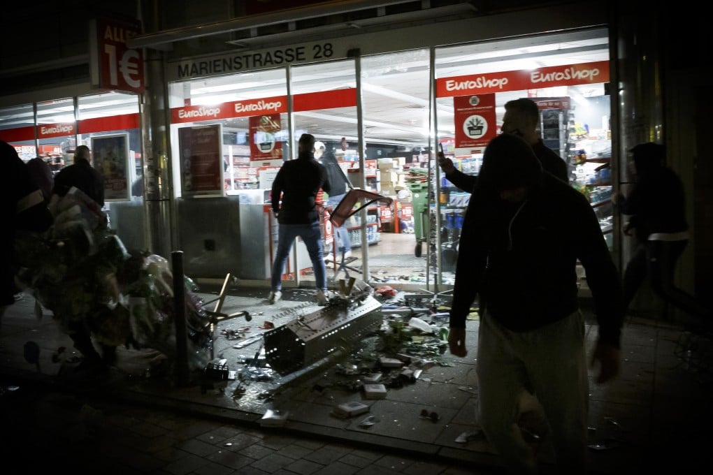 Goods lie on the floor after people broke into a shop on Marienstrasse in Stuttgart, Germany, on Sunday. Photo: DPA via AP