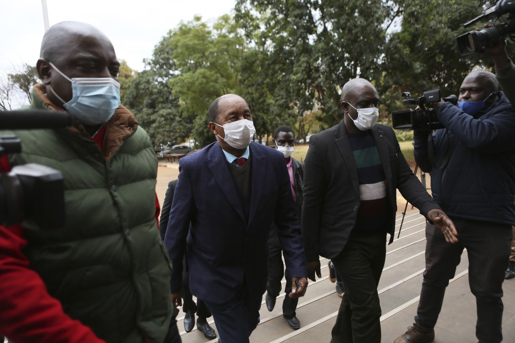 Zimbabwe's Health minister, Obadiah Moyo, centre, makes a court appearance at the magistrates courts in Harare. Photo: AP Photo