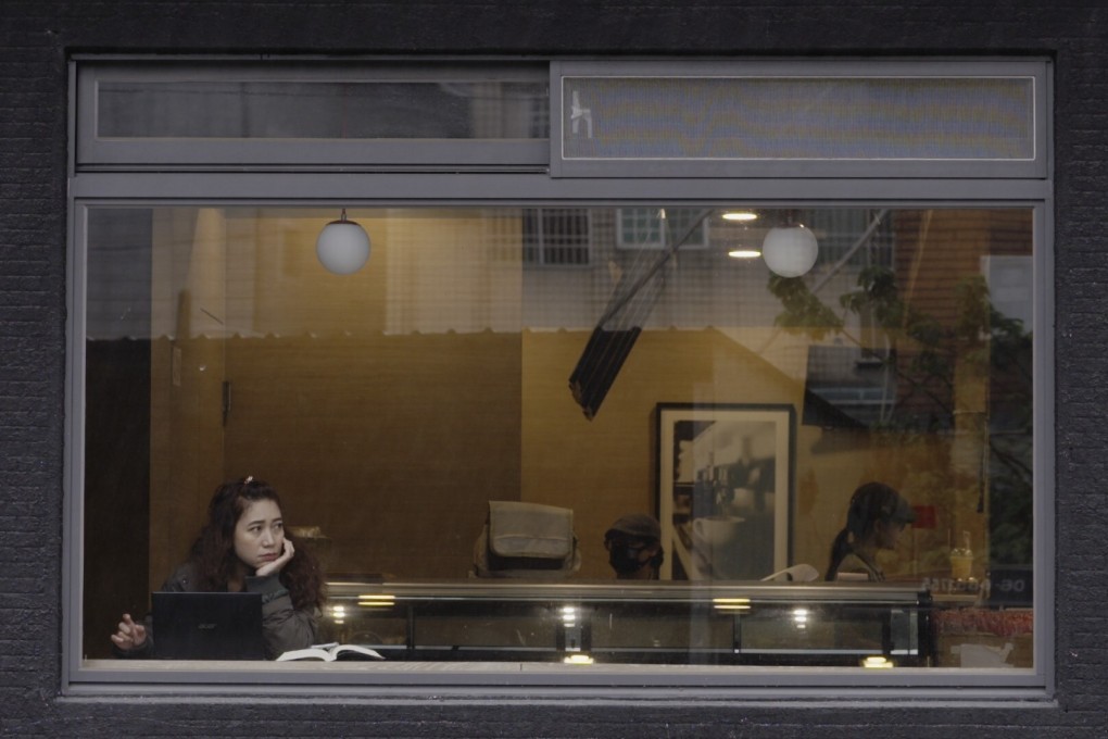Tari, one of four Indonesian workers followed in the award-winning documentary Help is on the Way, at a cafe in Taichung, an industrial city in Taiwan.