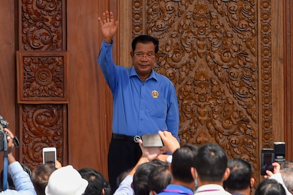 Cambodia's Prime Minister Hun Sen waves during his visit to the Cambodian People's Party headquarters, currently under construction in Phnom Penh. Photo: AFP