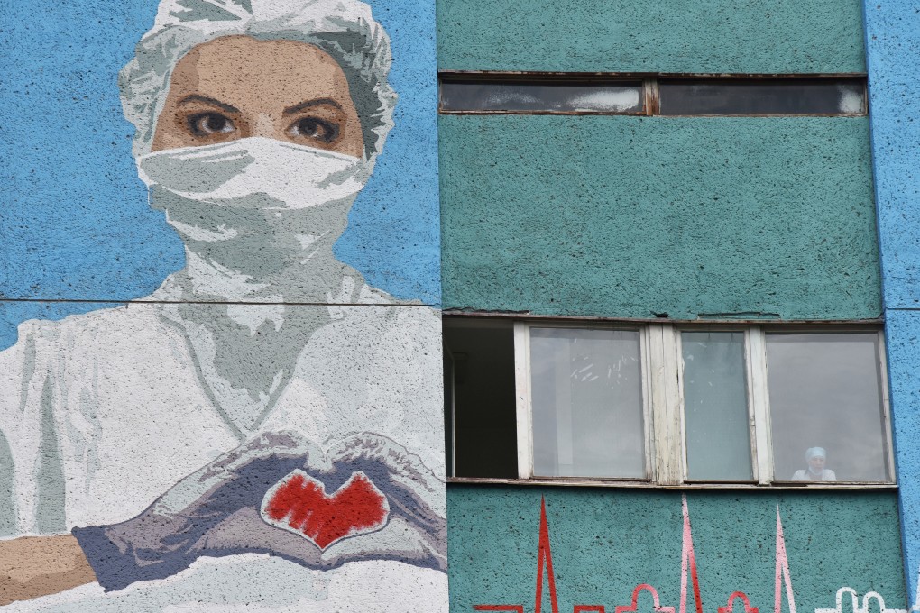 A mural depicting a health care worker is seen on a wall of the City Emergency Hospital in Lviv, Ukraine on Sunday. Photo: Reuters