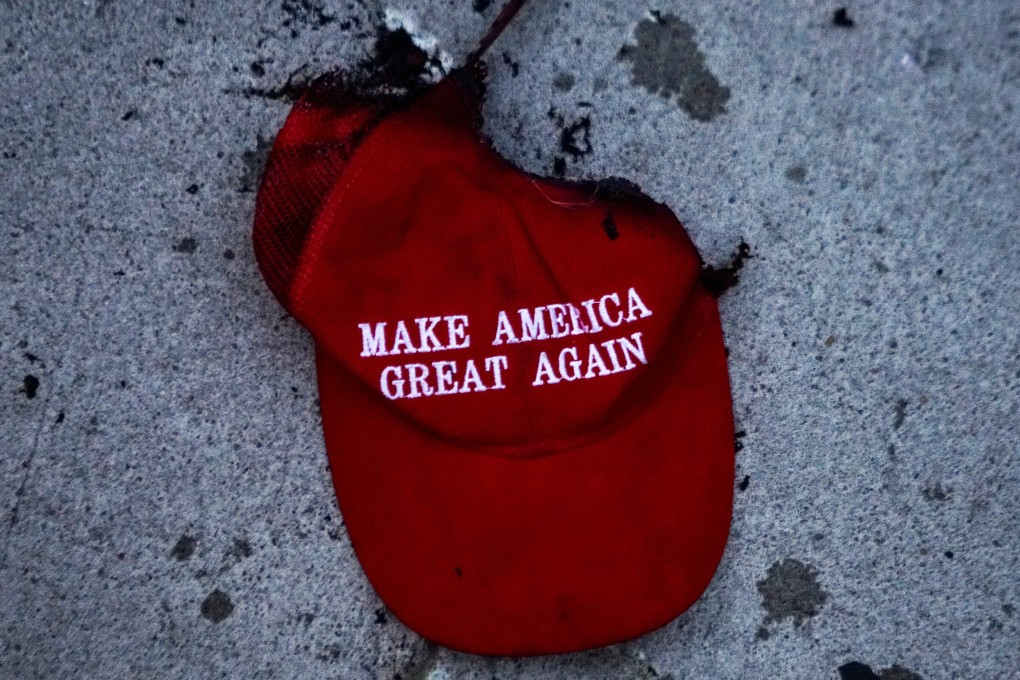 A burnt Make America Great Again hat lies on the ground during a protest near the site of US President Donald Trump’s rally in Tulsa, Oklahoma, on Saturday. Photo: Reuters