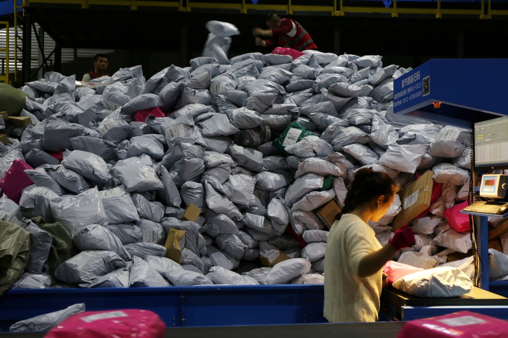Employees sort out parcels at a logistics base in Yiwu, a city in eastern Zhejiang province, during China’s Singles’ Day shopping festival on November 11, 2019. Photo: Reuters