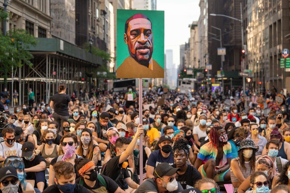 Protesters march down Fifth Avenue in New York demanding police reform on June 10. Held aloft is a picture of George Floyd, a 46-year-old African-American who died during a police arrest in Minnesota two weeks before. Photo: AFP
