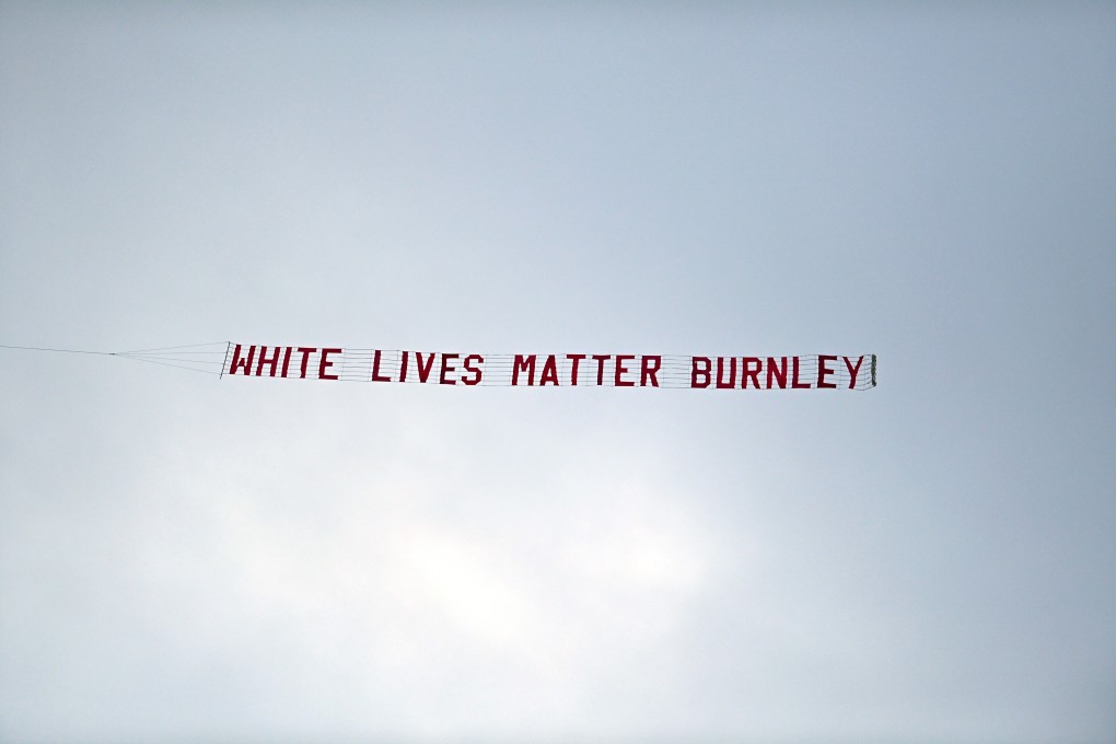 A small aircraft (out of frame) flies a banner which reads ‘White Lives Matter Burnley’ over the Etihad Stadium at the start of the Premier League match between Manchester City and Burnley. Photo: EPA