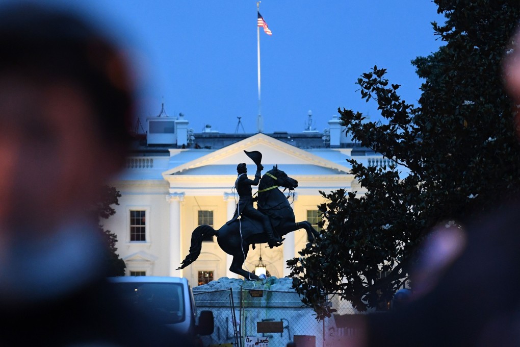 A row of police officers stand guard in front of the equestrian statue of former US President General Andrew Jackson after protesters tried to topple it. Photo: AFP