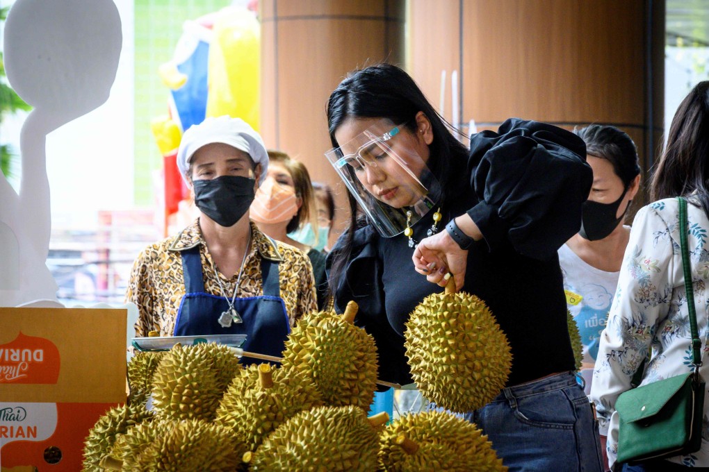 A vendor sells durians at a street stall in Bangkok in May. Photo: AFP