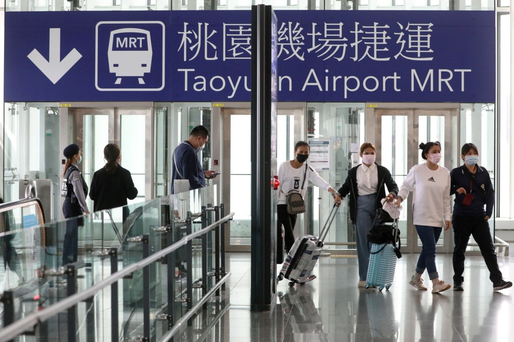 Travellers arrive at Taipei’s Taoyuan airport in March, before foreign travellers and international flight transfers were suspended. Photo: Reuters