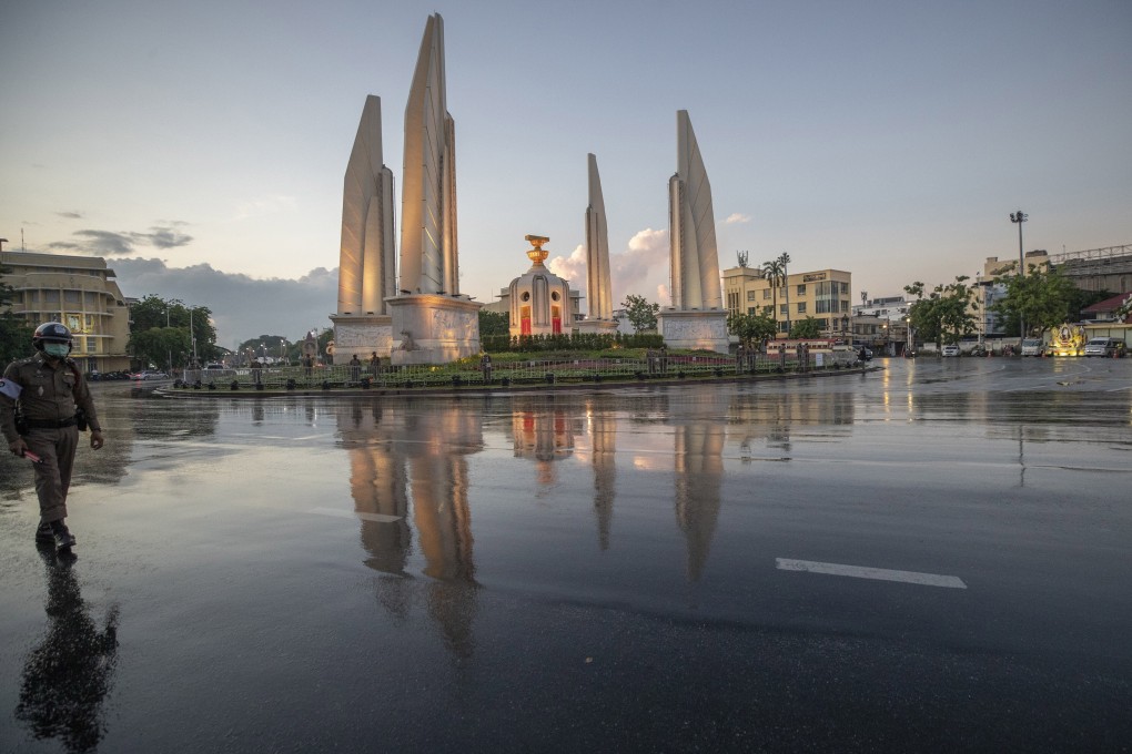 A policeman walks in front of Democracy Monument after anti-government activists protested in front of it to mark the anniversary of the proclamation that ended absolute monarchy in Thailand. Other statues and monuments marking this are disappearing. Photo: AP