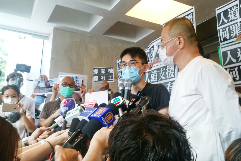 Social worker Lau Ka-tung (in black) speaks outside the High Court on Tuesday after being granted bail. He is appealing a conviction for obstructing police last July at an unauthorised rally in Hong Kong’s Yuen Long area. Photo: Brian Wong