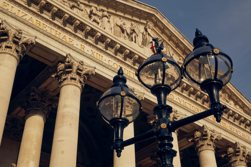 A statue of a City of London dragon stands on a street lamp outside the Royal Exchange in the City of London. Photo: Bloomberg
