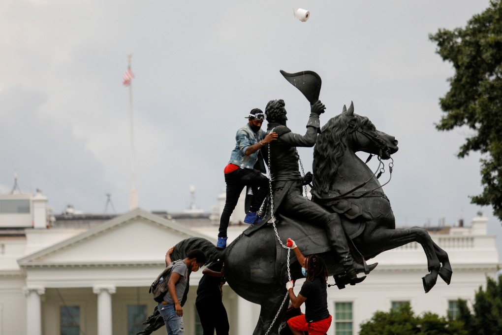 Protesters attempt to topple the statue of US President Andrew Jackson in the middle of Lafayette Park, near the White House. Photo: Reuters