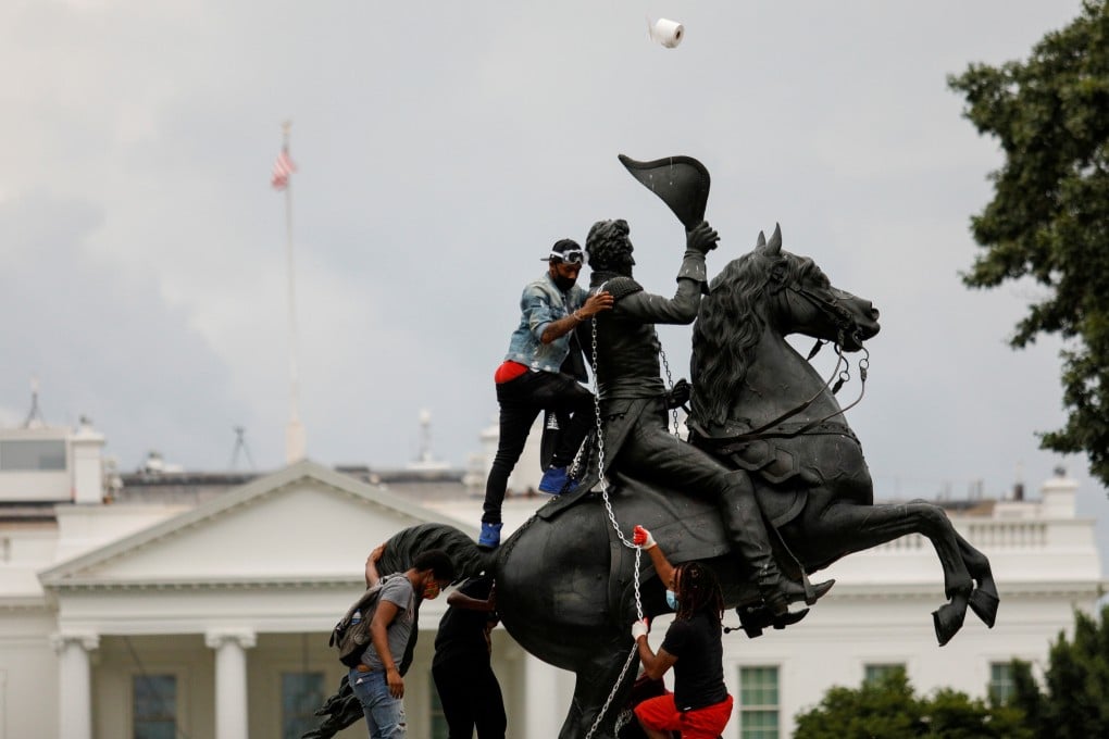 Protesters attempt to topple the statue of US President Andrew Jackson in the middle of Lafayette Park, near the White House. Photo: Reuters