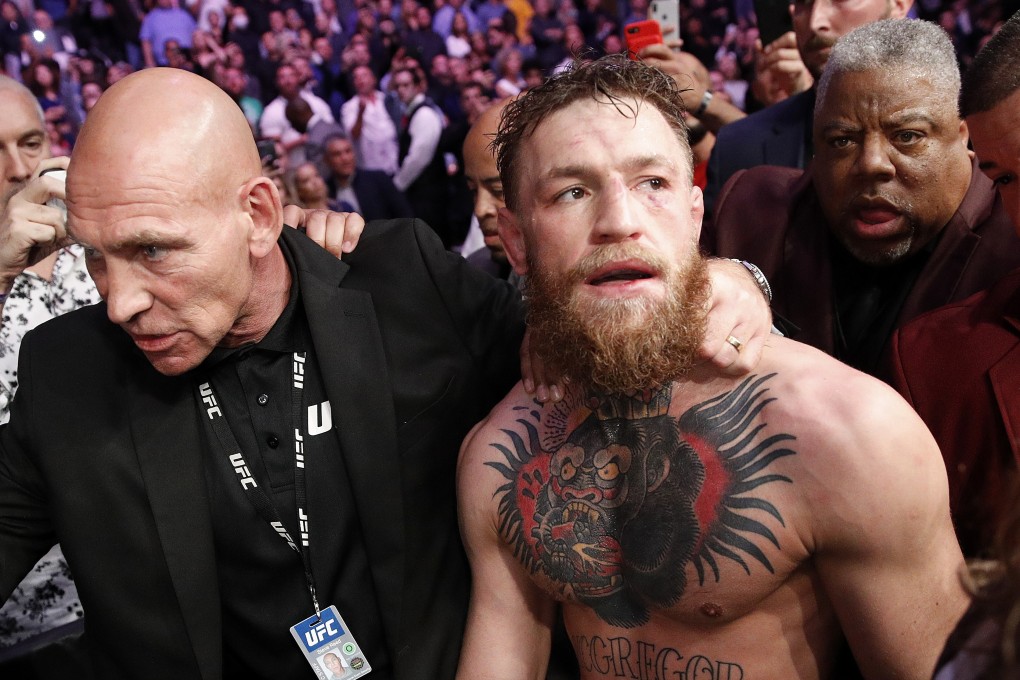 Conor McGregor is escorted from the Octagon area after fighting Khabib Nurmagomedov at UFC 229. Photo: AP