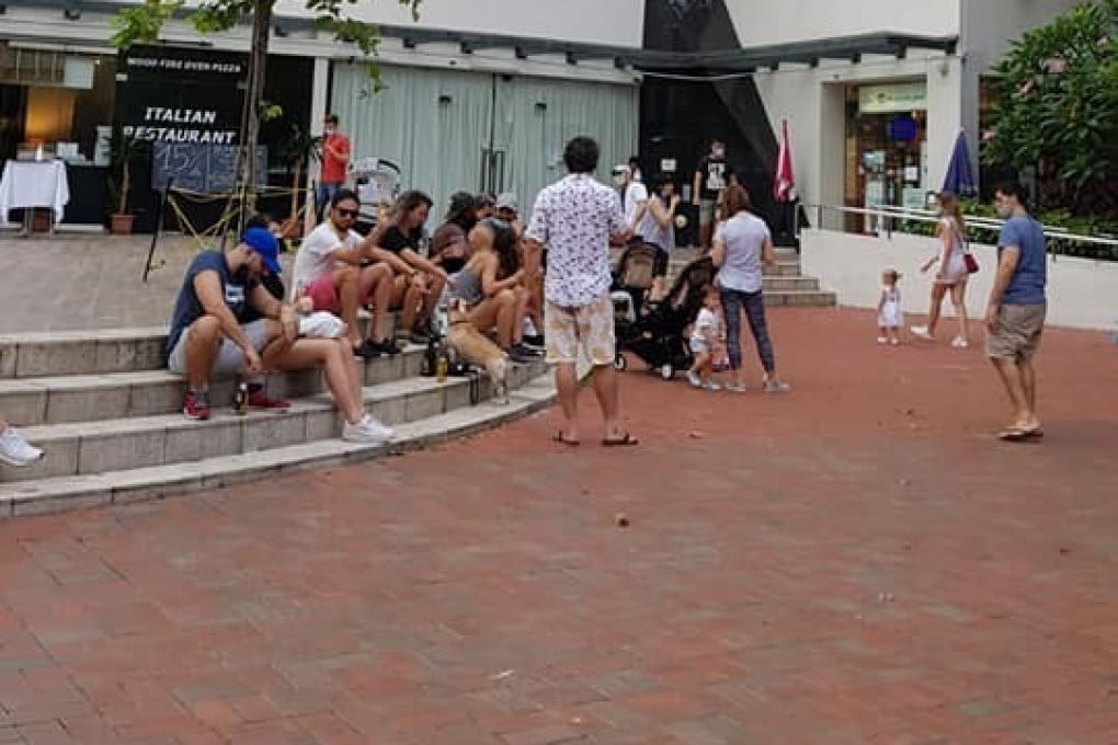 People are seen outside a restaurant in Robertson Quay in Singapore in May, during the circuit breaker restrictions. Seven foreigners have been fined for flouting social distancing rules. Photo: Facebook