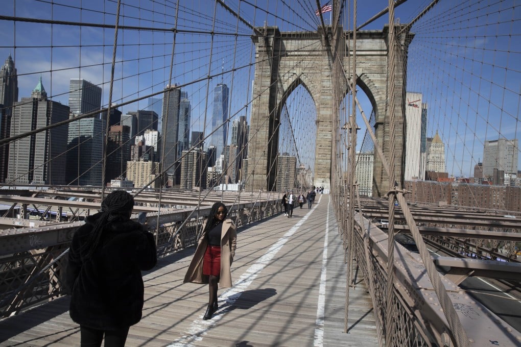 People walk across the Brooklyn Bridge in New York on Monday. Photo: AFP