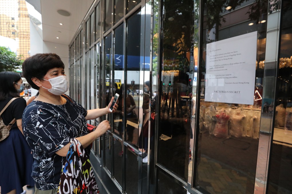 A woman reads a notice posted at Victoria’s Secret that it has closed its flagship store in Causeway Bay. Photo: May Tse