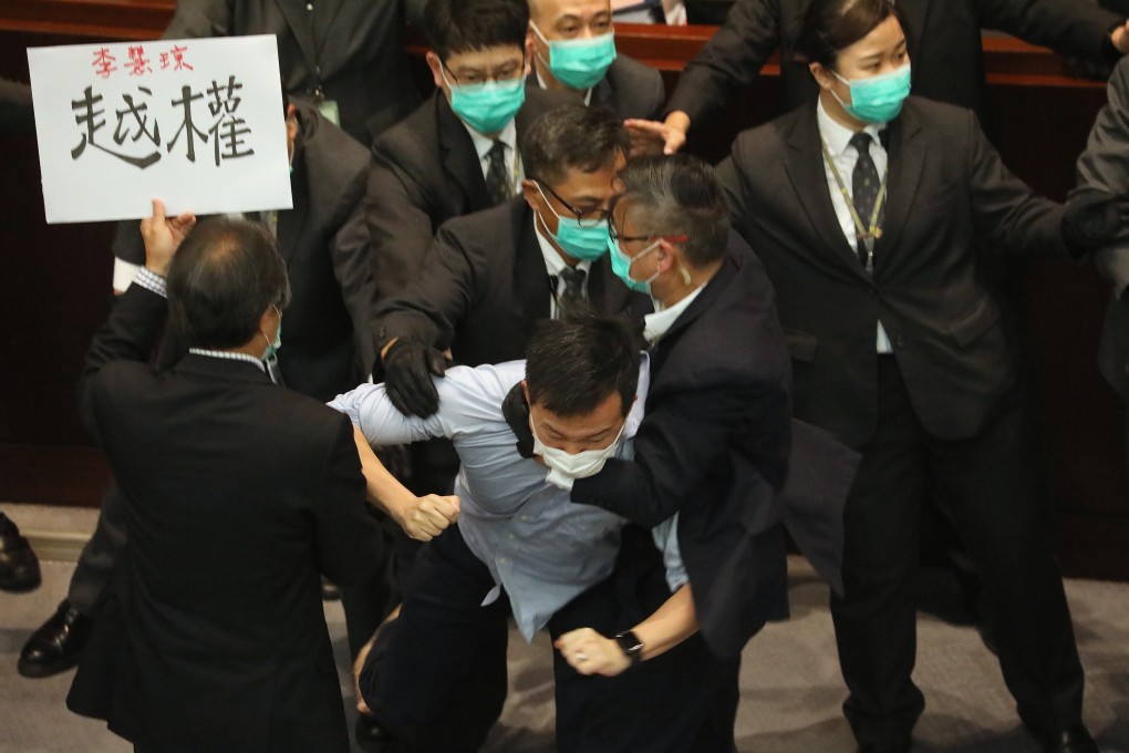Opposition lawmaker Raymond Chan Chi-chuen (centre) struggles with security staff at a Legislative Council meeting last month, a sight which has become all too common in Hong Kong. Photo: Dickson Lee