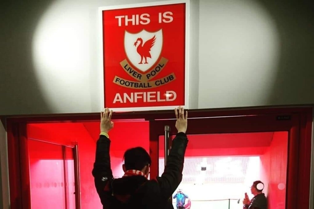 Alton Hwang touches the 'This is Anfield' sign during a visit to the famous stadium in 2018. Photo: Handout