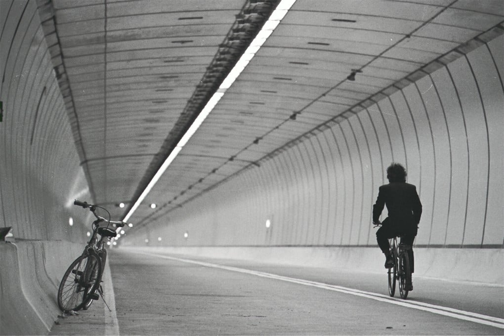 A security guard cycles through the new Tate’s Cairn Tunnel, in 1991. Photo: SCMP